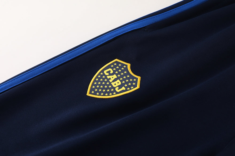 c49d1002 | UAE SPORT STORE Dark navy fabric with a yellow shield logo outlined with stars and the letters CABJ.