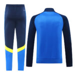 c4b56b63 | UAE SPORT STORE Athletic tracksuit: blue and navy jacket with matching pants, yellow stripe near the lower legs on the pants