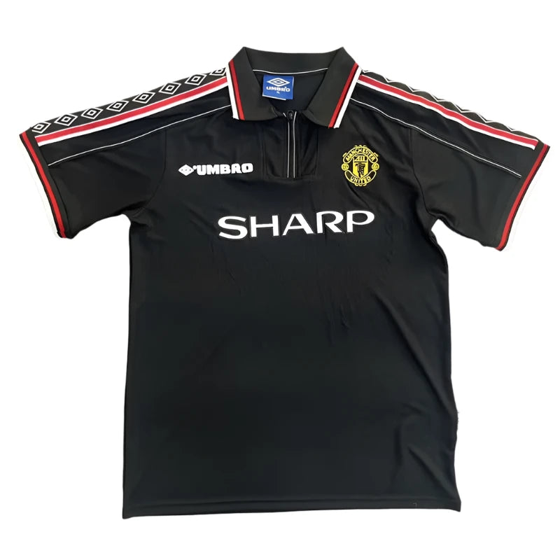 c509ddb25dce4605 Black Manchester United football jersey with SHARP sponsor, Umbro logo, and club crest on the chest; red and white piping on sleeves.