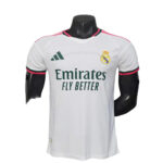 White Real Madrid soccer jersey on a mannequin, with Emirates Fly Better sponsor and club crest on chest.