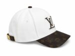 White baseball cap with a brown monogrammed brim and Louis Vuitton logo on the front, adjustable back strap in gold hardware