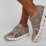 Beige breathable-mesh athletic sneakers with a thick white sole and laced front, OC logo on the side.