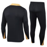 Black athletic tracksuit set (jacket and pants) with tan side panels, shown from back view on a white background