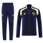 c617f608 | UAE SPORT STORE Navy blue Adidas tracksuit with yellow accents; zip-up jacket with club crest and matching pants.