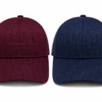 Two Christian Dior Couture baseball caps in burgundy and navy, featuring a subtle Dior monogram pattern and embossed logo on the front panel.