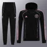 Black Adidas tracksuit with pink piping, hoodie-style jacket and matching joggers.