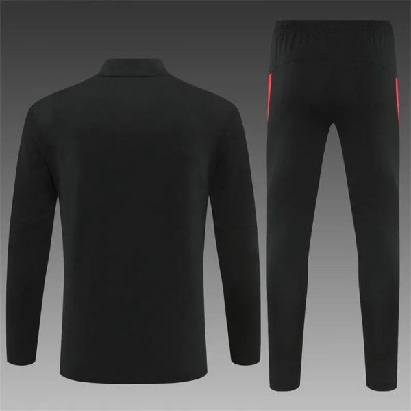 Black tracksuit set with jacket and matching pants shown against a gradient background; back view of the jacket and front view of the pants with subtle red side accents.