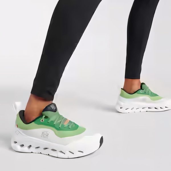 Person wearing lime green chunky sneakers stepping forward while wearing black leggings/leggings.