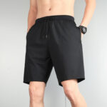 Black athletic shorts with drawstring waist, side pockets, and a small Adidas logo on the left thigh area.