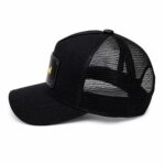Black trucker cap with a Batman emblem patch on the front panel and a mesh back.