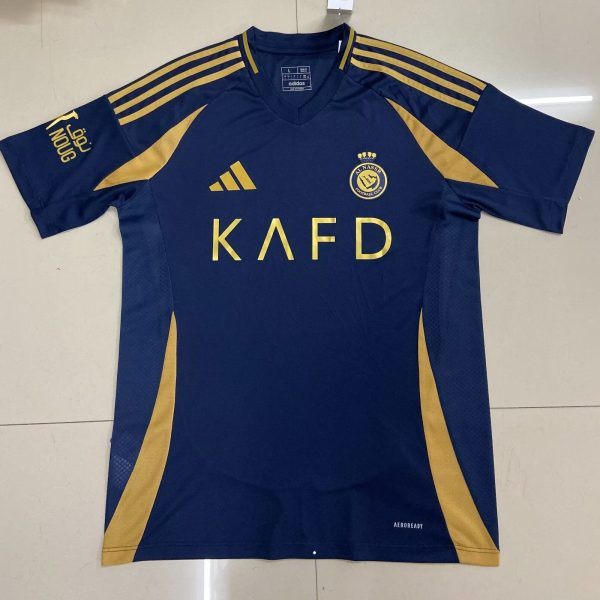 Navy blue Adidas soccer jersey with gold accents, including three gold stripes on the shoulders, a gold crest on the chest, and the letters KAFD across the front.