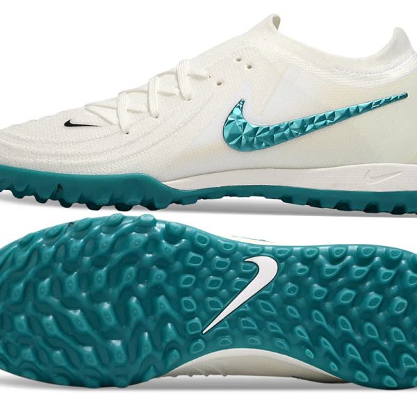 White Nike turf soccer cleat with teal studded outsole and turquoise Swoosh on the side