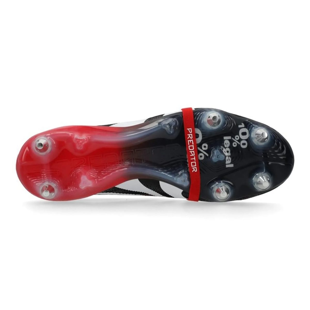 Close-up of a Predator football boot: red toe, black body, red strap, and studded sole visible