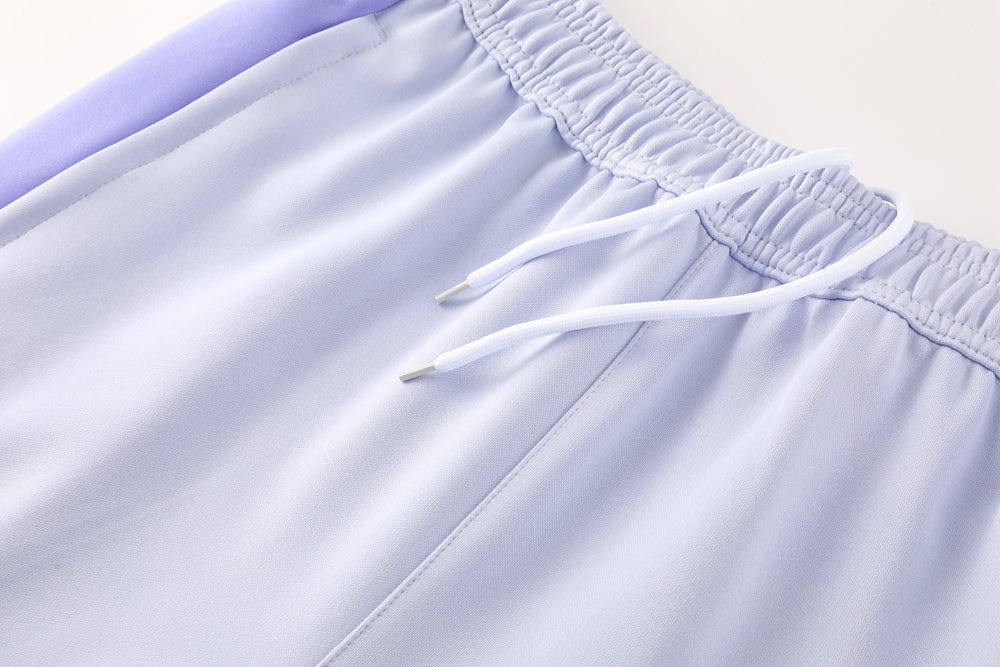 c91eba44 | UAE SPORT STORE Light lavender athletic shorts with an elastic waistband and white drawstring close-up.