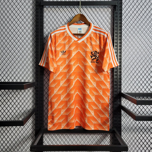 Orange Netherlands soccer jersey on a hanger, showing Adidas logo and KNVB crest on the chest.