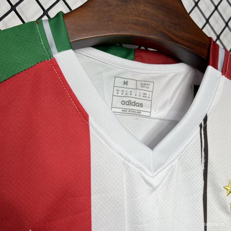 caaeb7dbe4dcb3c9 | UAE SPORT STORE Close-up of a white Adidas sports jersey on a wooden hanger, showing red and green color blocks and a stitched collar with a visible size tag inside the neck area.