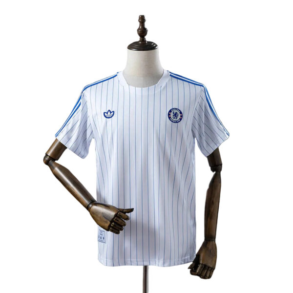 Chelsea FC white pinstripe football jersey displayed on a mannequin, featuring the Adidas logo and team crest on the chest.