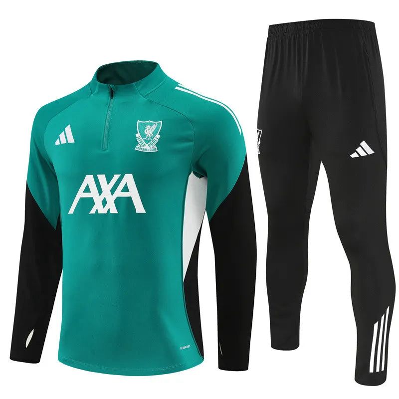 cb11aee1-7b8f-4661-aa8e-ccf13d11926a | UAE SPORT STORE Teal training jersey with club crest, white sponsor logo AXA, and black track pants with white Adidas stripes for a soccer kit.