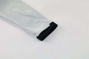 Light gray sleeve with a contrasting black inner cuff folded back at the end.
