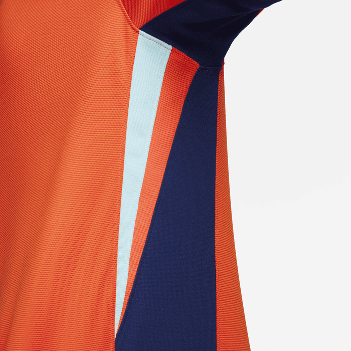 cc476c6e_4308_4965_9359_455e9c5a82d3 | UAE SPORT STORE Close-up of orange and navy color-blocked athletic fabric with a light blue stripe along the seam
