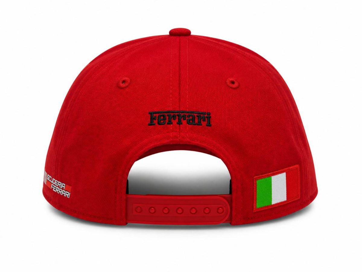 Back view of a red Ferrari cap with an adjustable strap and an Italian flag patch on the side.