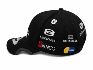 Black baseball cap with white embroidered brand logos (Balenciaga, BLCG) and a colored Mastercard emblem on the side; curved brim visible.