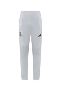 Light gray Real Madrid track pants with white piping and an Adidas logo on the front, shown from the front.