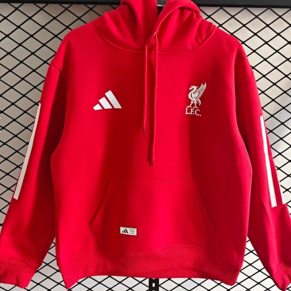Red Liverpool FC hoodie with Adidas logo and white sleeve stripes, front pouch pocket, hanging on a rack.