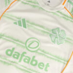 celtic-men-s-2025-26-third-shirt-1180888103 | UAE SPORT STORE Close-up of a white jersey with mint-green tie-dye pattern, displaying the Dafabet sponsor text and Adidas logo.