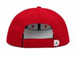 Red performance mesh cap with adjustable strap and Jordan logo.