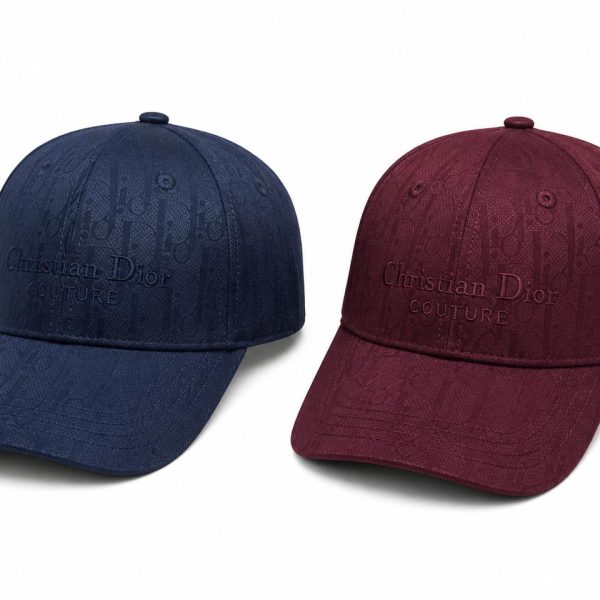 Two Dior couture baseball caps in navy blue and burgundy with embossed logo.