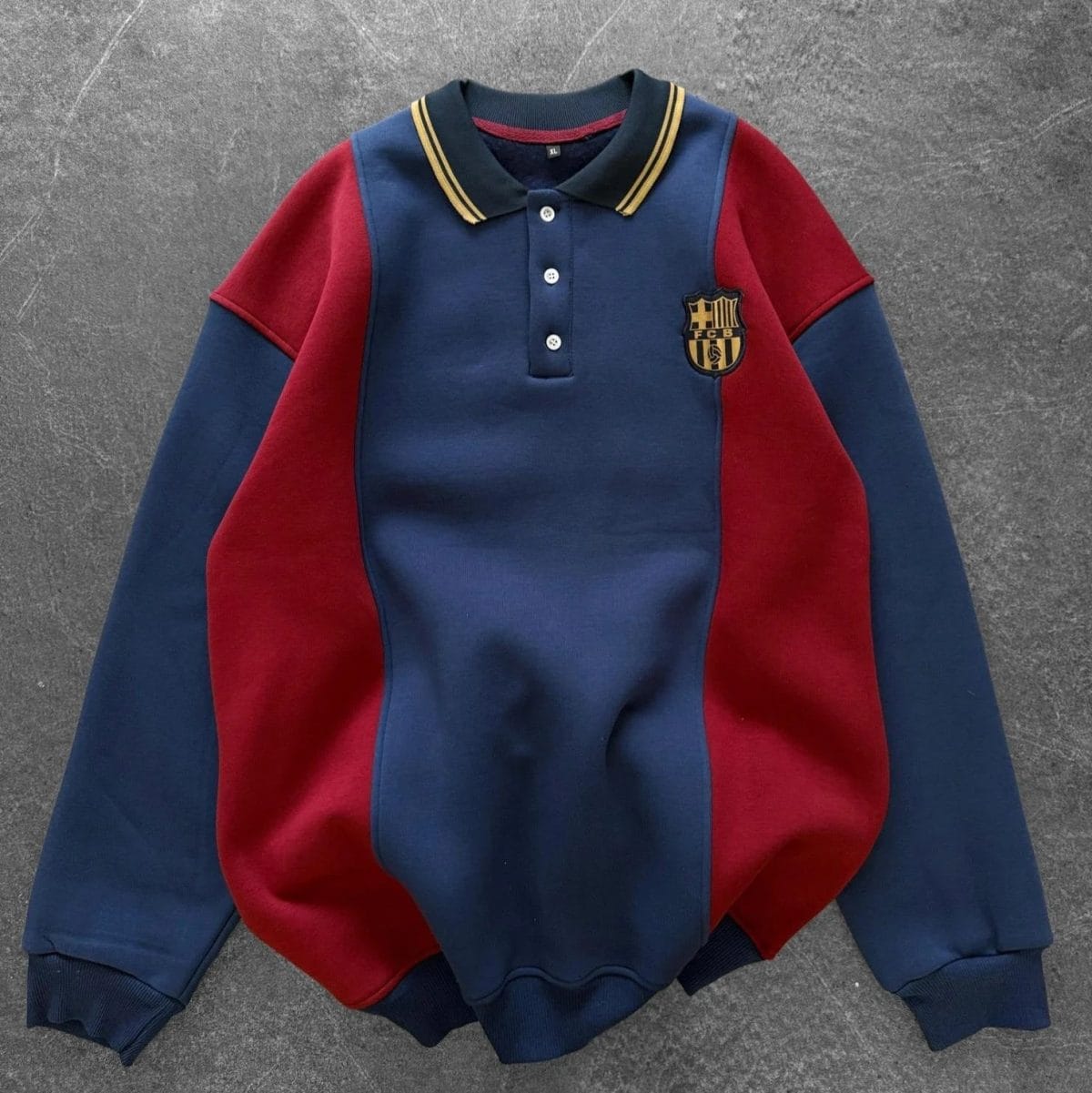 Dark blue and maroon color-blocked polo sweatshirt with FC Barcelona crest on the left chest, ribbed cuffs and hem.