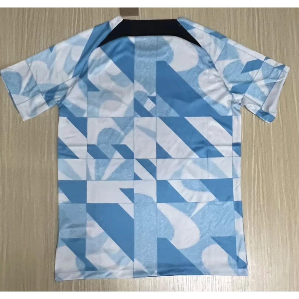 cn-11134207-7r98o-lq7wvcpuykuw10 | UAE SPORT STORE Blue and white geometric print short-sleeve shirt on a hanger.