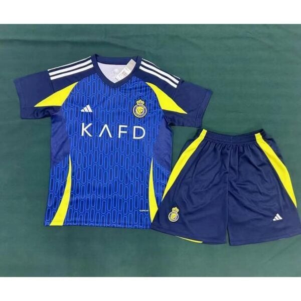 Blue soccer jersey with yellow panels and crest, 'KAFD' sponsor across chest, paired with blue shorts that have yellow side panels.