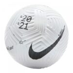 Close-up of a white Nike soccer ball with a black swoosh, textured panels, and year markings on the surface.