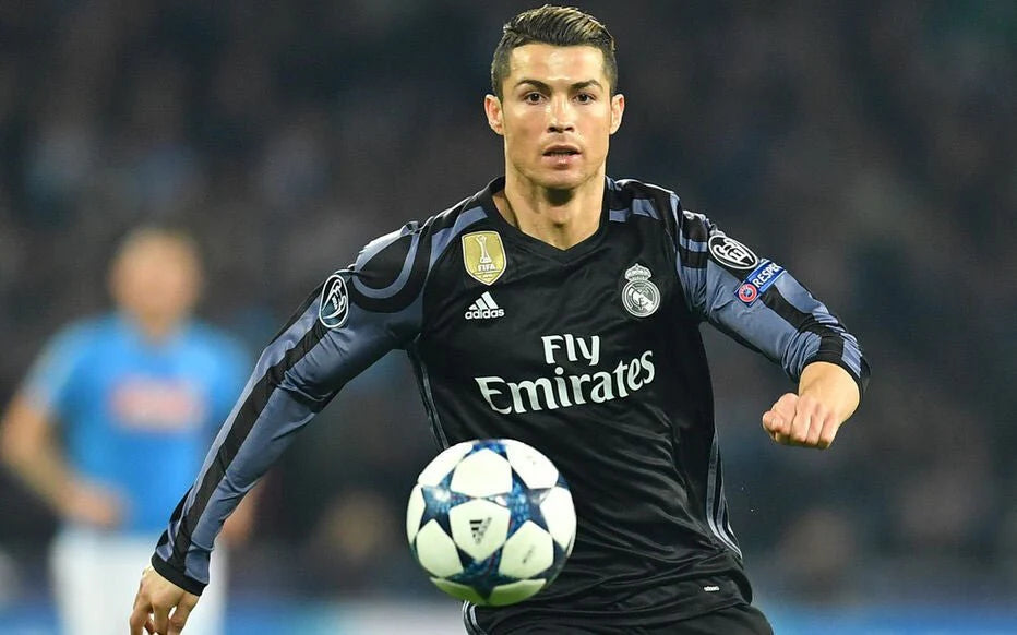 cristiano-ronaldo-real-madrid-2016-2017-third-jersey-shirt-camiseta-bnwt-m-sku-ai5139-547096_1024x1024_576cc9b3-fae4-4df9-8731-e5f65b9e8283 | UAE SPORT STORE Cristiano Ronaldo in Real Madrid away kit, controlling a soccer ball during a match on the field.