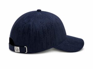 Navy blue baseball cap with embossed Dior monogram pattern and back strap with silver buckle
