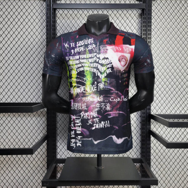 Polo-style graphic T-shirt with a multicolor abstract graffiti print and white handwritten text, displayed on a black mannequin in a retail display.