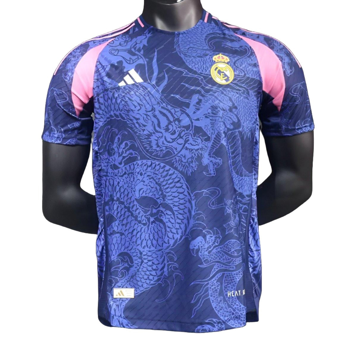 d0d7733300af0818911c9820 Blue Real Madrid football jersey with a dragon pattern, pink shoulder panels, Adidas logo, and team crest on the chest.