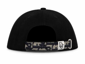 Back view of a black baseball cap with an adjustable camo strap and silver buckle.