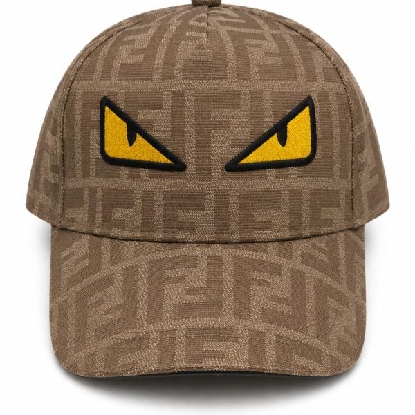 Brown patterned baseball cap with a bold yellow angry-eye patch on the front panel for a playful, edgy look.