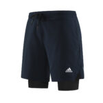 d29890bb | UAE SPORT STORE Navy blue Adidas athletic shorts with a black drawstring and inner black compression shorts visible beneath. Logo on the right leg.