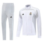 White Real Madrid training tracksuit with jacket and pants, grey side panels, Real Madrid crest on chest, Adidas logo on both pieces.