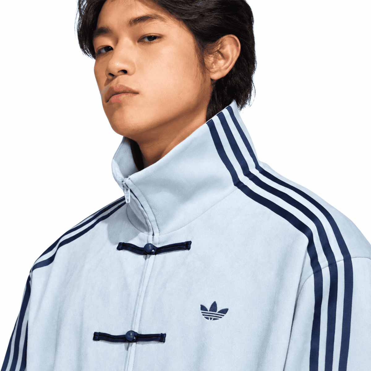 Light grey Adidas casual jacket with blue stripes and trefoil logo.