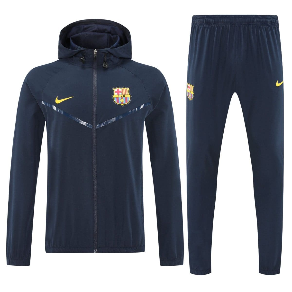 Navy blue FC Barcelona tracksuit jacket with hood and matching pants, featuring the club crest and a yellow Nike logo.