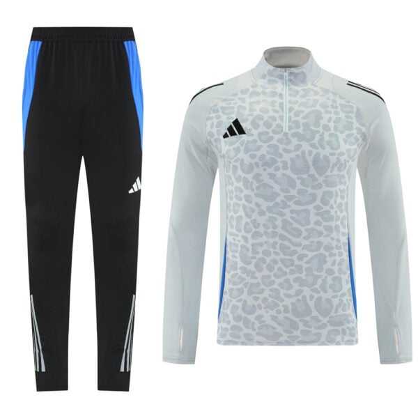 Matching training set: black pants with blue side panels, and a light gray leopard-print long-sleeve top with a zip and Adidas logo.