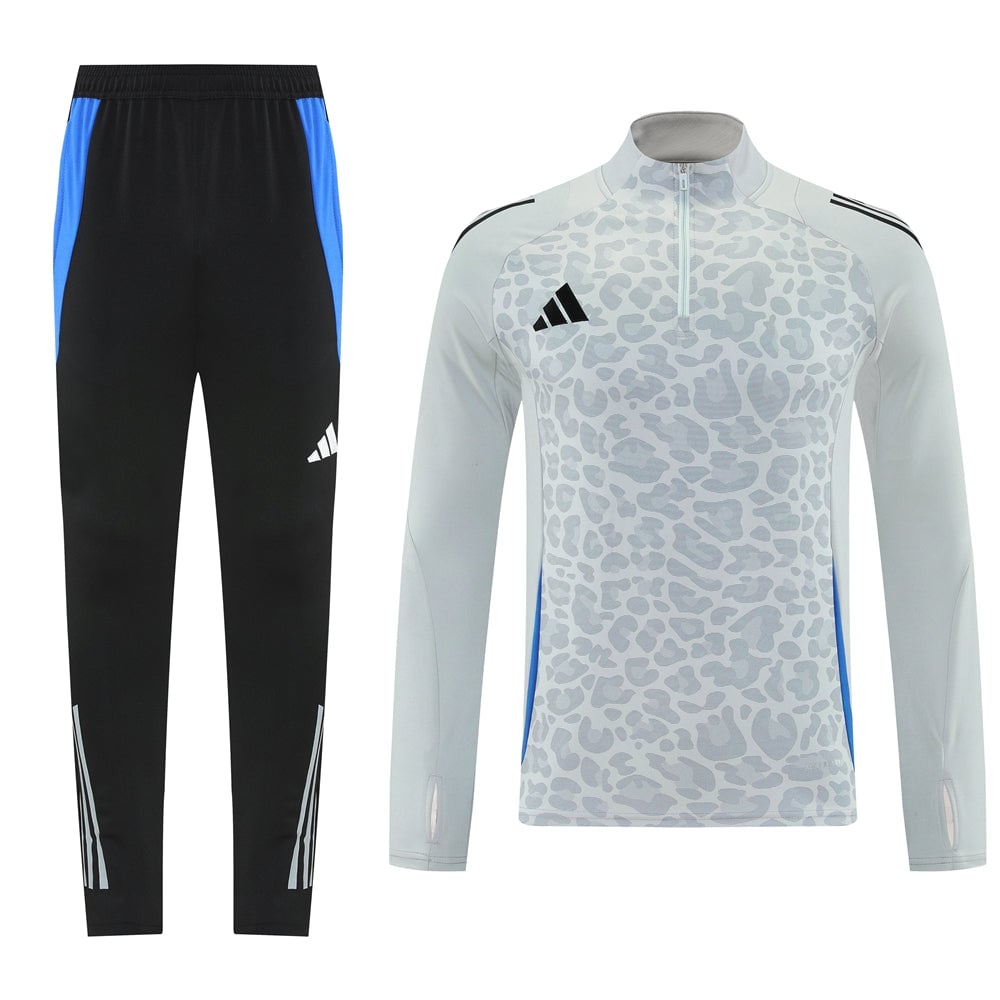 d51de502 Matching training set: black pants with blue side panels, and a light gray leopard-print long-sleeve top with a zip and Adidas logo.