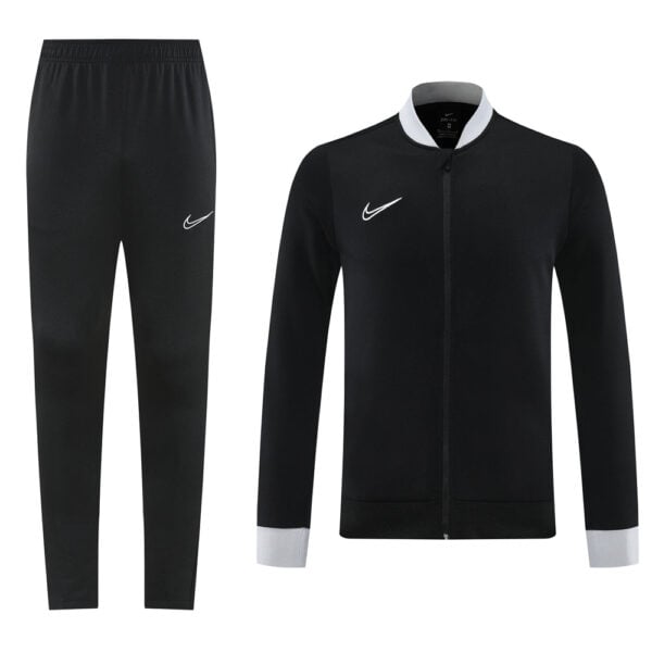 Black Nike tracksuit set: full-zip jacket with grey cuffs and collar, paired with black jogger pants showing a white Nike swoosh.
