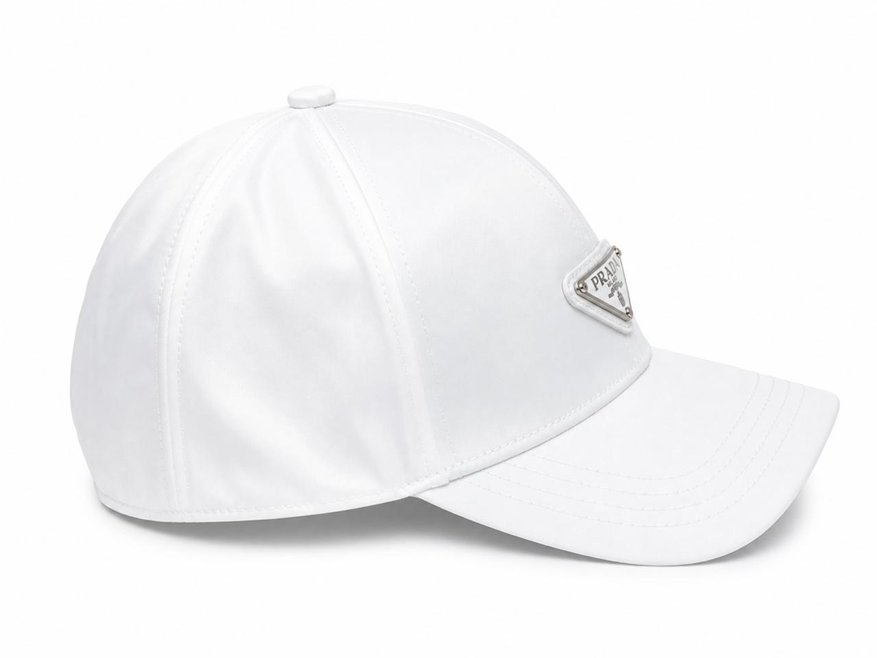 d68de870-da05-4653-8117-bd6eb2720e8e | UAE SPORT STORE White baseball cap with a triangular Prada logo badge on the front and a curved brim.