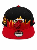 Black and red Miami Heat snapback cap with city skyline and flaming basketball logo on the front panel, brim red, side patch visible.
